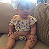 baby, child, infant, couch, sofa, headband, bow, clothing, pattern, lemon, sitting, indoors, furniture, cute, skin, face, legs, arms, window, light