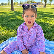 Leanne joined the competition — help win amazing prizes! child, girl, toddler, portrait, smiling, outdoor, park, grass, trees, sunlight, sunglasses, pajamas, pink_clothing, blue_blanket, sitting, tablet, playground, daylight, long_hair, happy