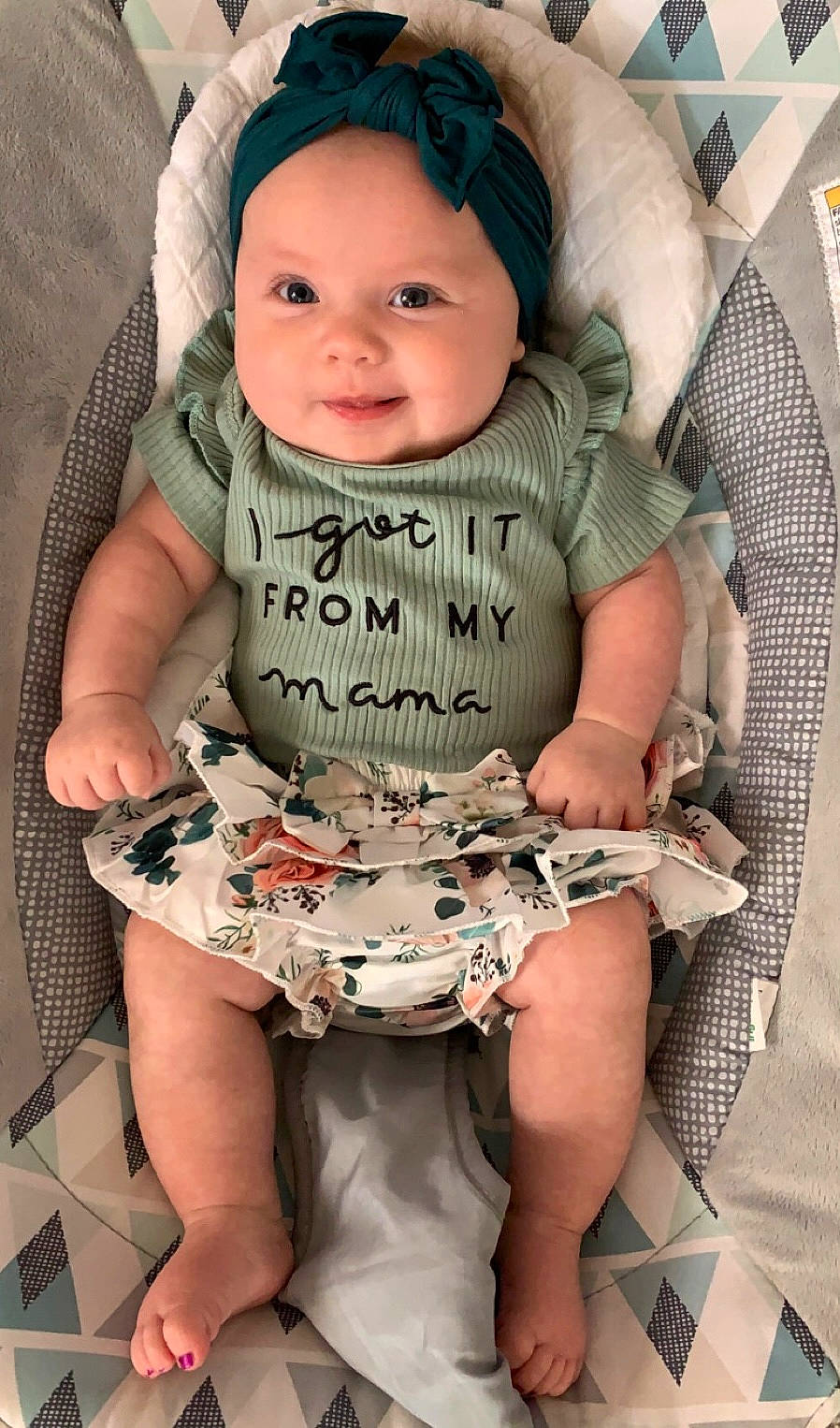 Emily joined the competition — help win amazing prizes! baby, baby_products, baby_toddler_clothing, chair, cheek, child, comfort, eye, face, happy, head, headwear, lap, leg, pattern, person, pink, skin, sleeve, smile