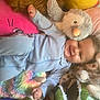 Bowie joined the competition — help win amazing prizes! baby, bed, blue_onesie, child, colorful_blanket, cozy, cute, green_crocodile, grey_bird, happy, indoors, infant, lying_down, pink_pillow, playful, plush_toy, smiling, soft_toys, stuffed_animal, yellow_pillow