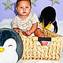 baby, baby_boy, baby_girl, basket, blue_eyes, child, childrens_clothing, cozy, cute, decor, indoor, penguin, plush_toy, portrait, seated, soft_lighting, soft_toy, star_decoration, toy, woven