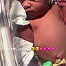 Stormi is registered to the contest to win money with this photo: newborn, baby, infant, sleeping, hospital, bassinet, blanket, diaper, pacifier_clip, tissue, face, closed_eyes, portrait, lying_down, indoors,  의료, skin, head, hand, text_overlay