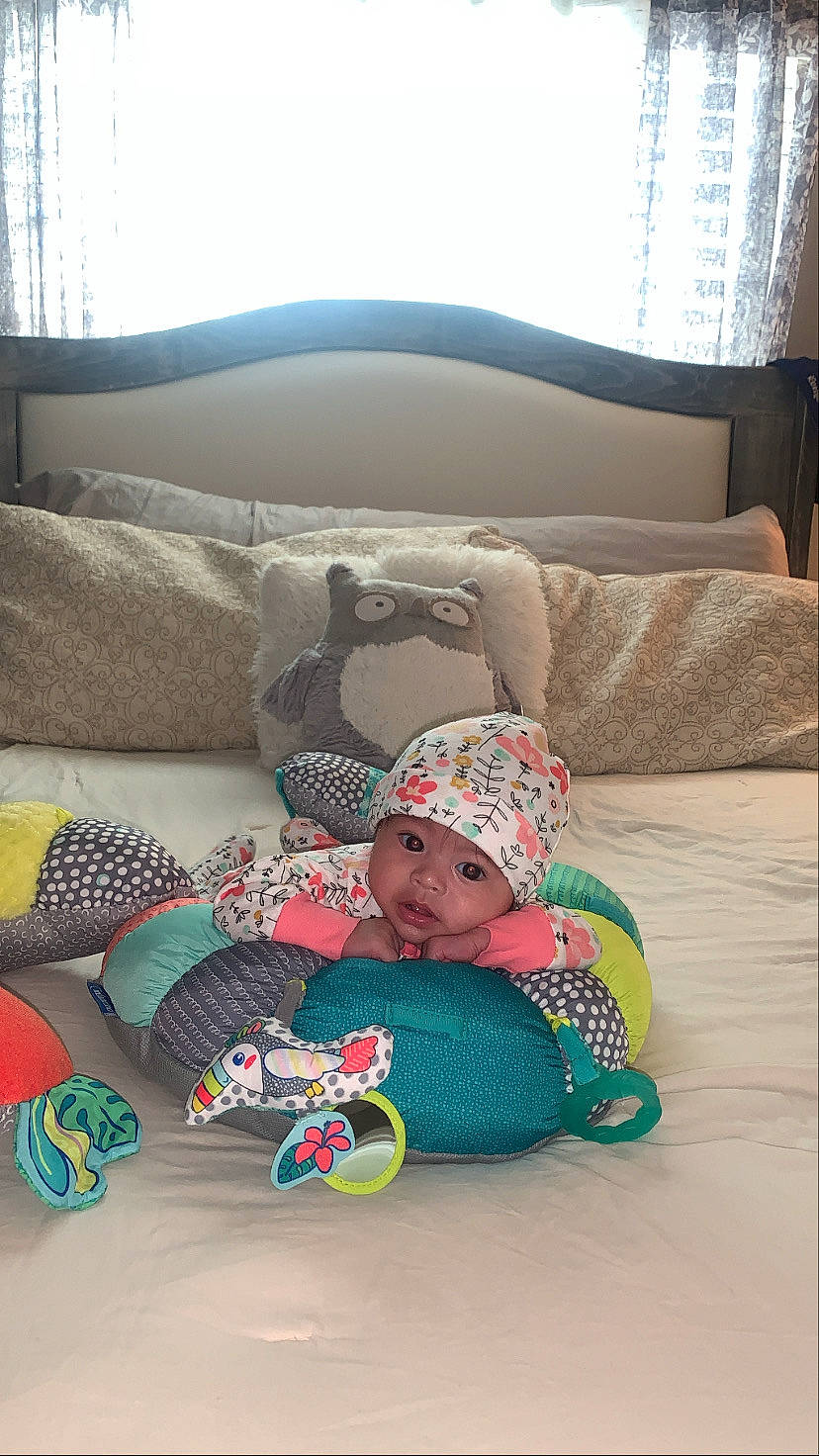 Coraline is registered to the contest to win money with this photo: baby_toddler_clothing, child, comfort, couch, curtain, flooring, headwear, home, leisure, linens, living_room, person, room, sitting, textile, toddler, tree, window, window_blind, window_treatment
