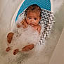 baby, bathtub, bubbles, bath, child, water, foam, skin, head, face, person, young, relaxing, comfort, zigzag_pattern, blue, white, wet_hair, infant, bath_support