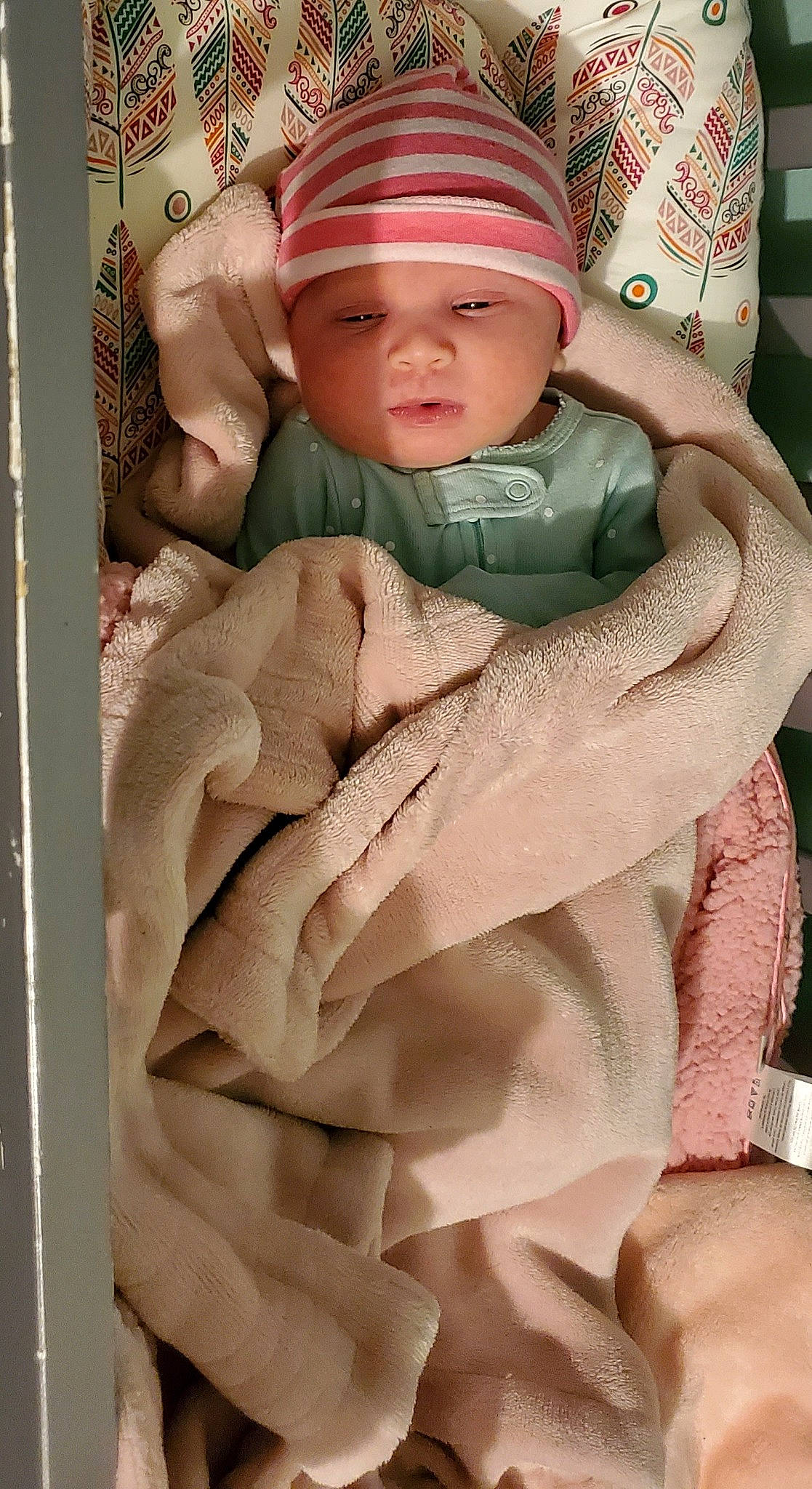 Alannah is registered to the contest to win money with this photo: baby, baby_carriage, baby_safety, baby_sleeping, baby_toddler_clothing, cap, cheek, child, chin, comfort, eye, face, gesture, headwear, linens, outerwear, person, pink, skin, sleeve