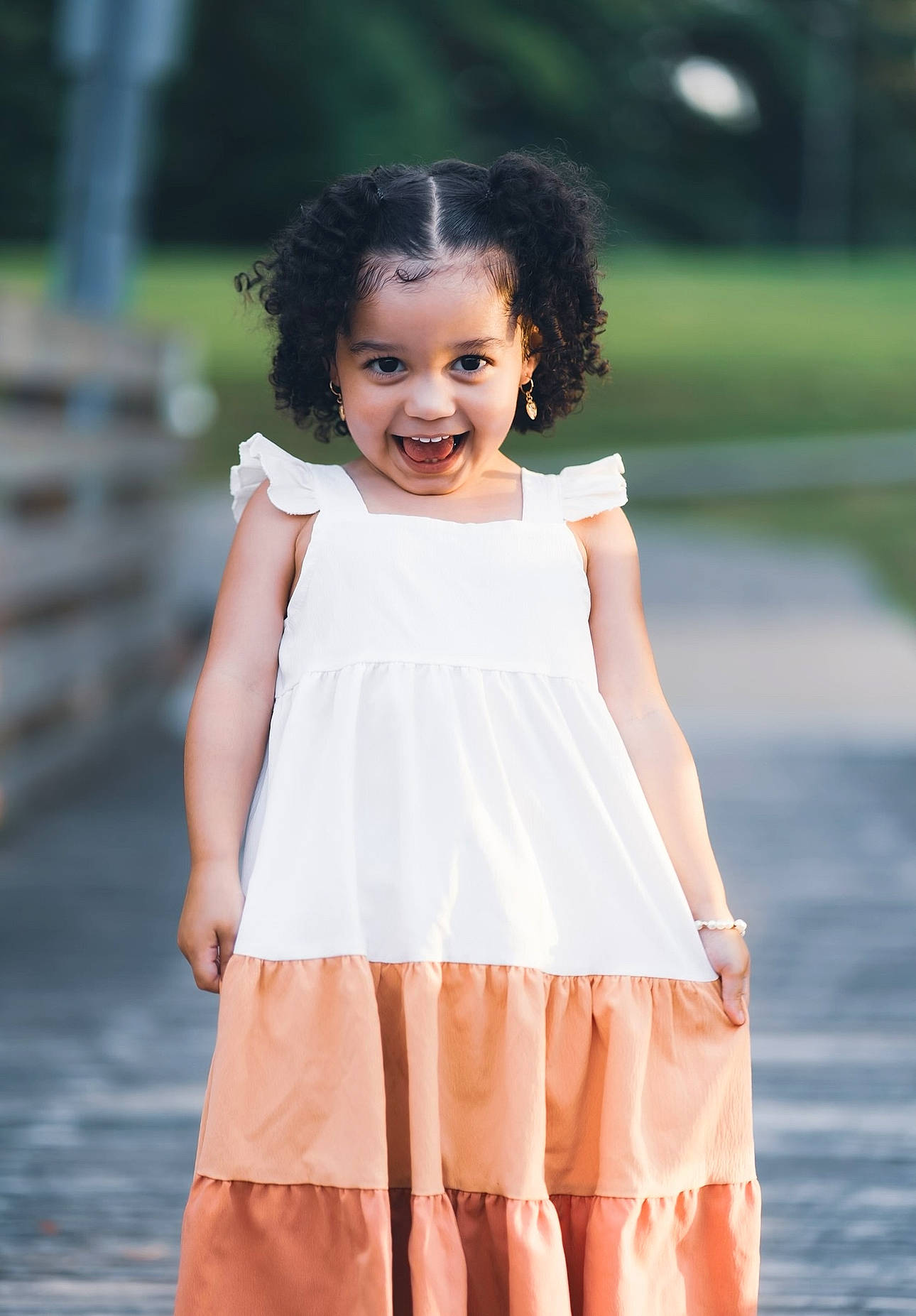 Rylee is registered to the contest to win money with this photo: baby_toddler_clothing, day_dress, dress, face, fashion_design, flash_photography, formal_wear, grass, hair, happy, joy, long_hair, neck, one_piece_garment, person, pink, ruffle, sleeve, smile, toddler