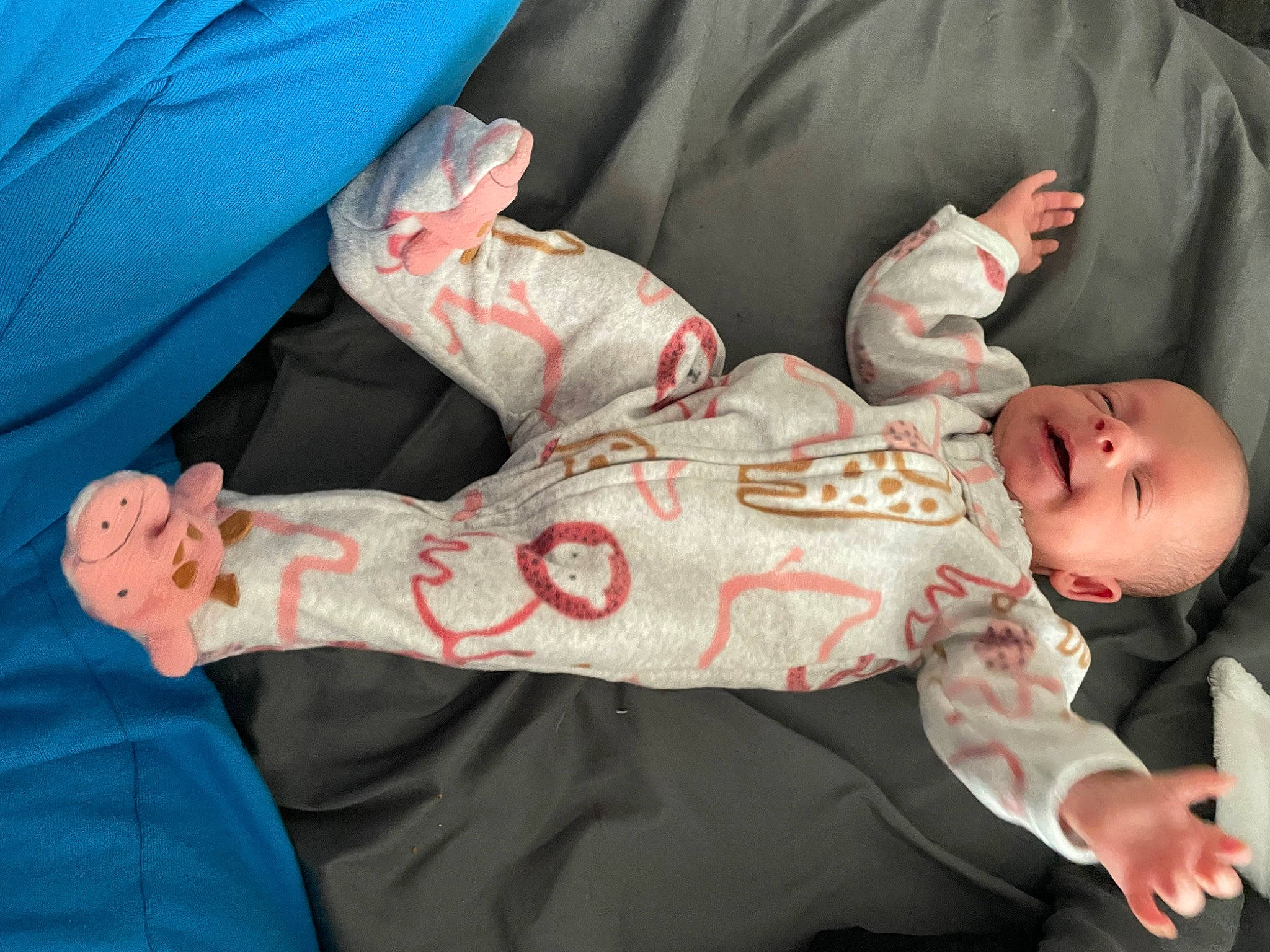 Kailani is registered to the contest to win money with this photo: arm, baby, baby_toddler_clothing, child, comfort, elbow, finger, gesture, hand, human_body, human_leg, knee, lap, leg, linens, person, room, sleeve, textile, toddler