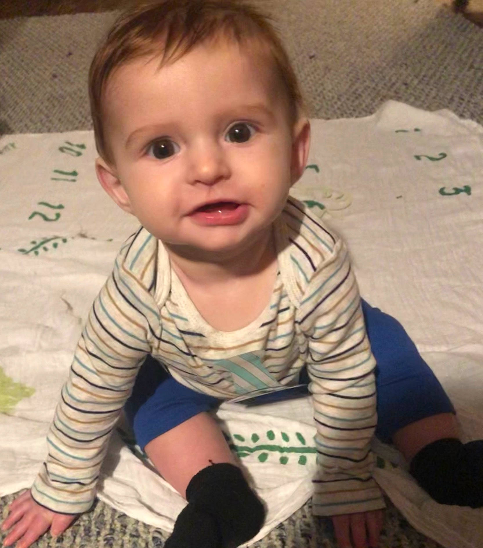 Alaric is registered to the contest to win money with this photo: baby, baby_toddler_clothing, cheek, chin, eyebrow, finger, floor, flooring, happy, head, iris, lip, mouth, neck, nose, person, skin, sleeve, standing, t_shirt