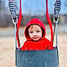 Phoebe joined the competition — help win amazing prizes! child, toddler, swing, playground, red_hoodie, outdoor, fall, leaves, seat, young, smiling, face, cute, person, fun, daylight, park, clothing, baby, nature