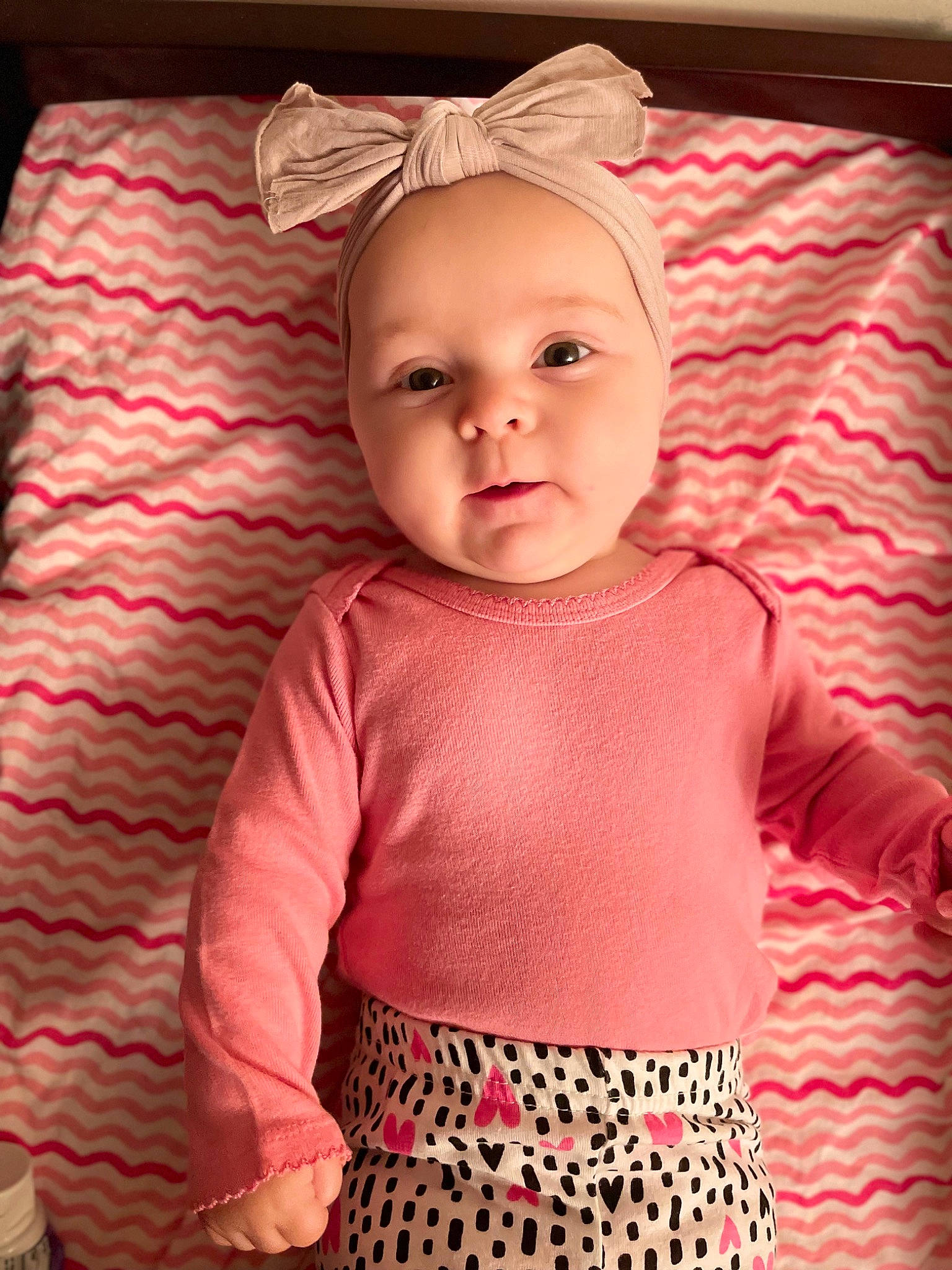 Mabel is registered to the contest to win money with this photo: baby, baby_toddler_clothing, cheek, child, comfort, eye, iris, linens, magenta, organ, outerwear, pattern, person, pink, product, skin, sleeve, smile, t_shirt, textile