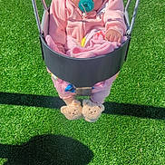 Autumn joined the competition — help win amazing prizes! baby, swing, pacifier, pink_clothing, hoodie, hat, blanket, fuzzy_slippers, playground, green_surface, child, outdoor, sunlight, cute, infant, seat, toy, soft_toys, person, playtime
