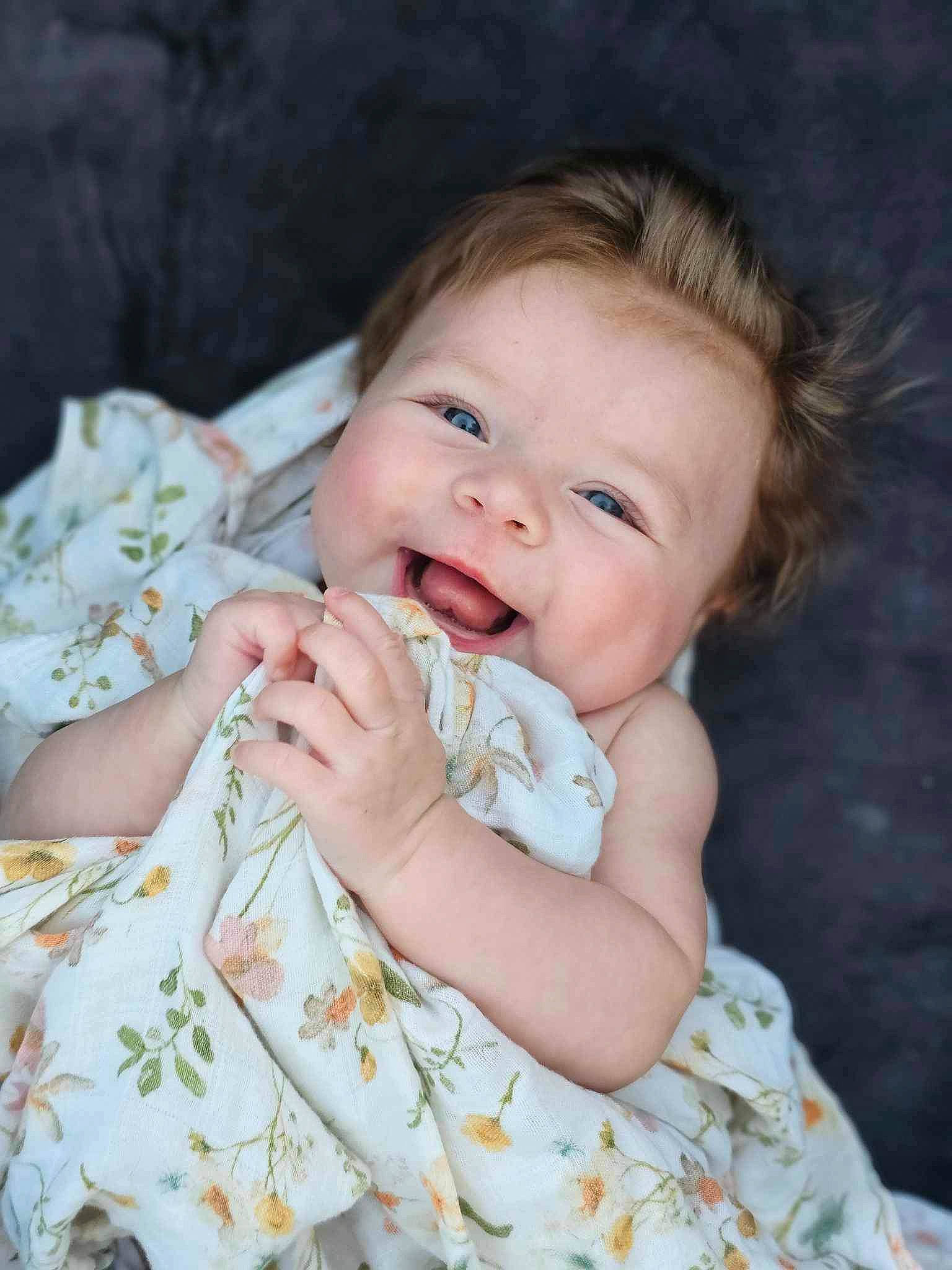 Karsyn is registered to the contest to win money with this photo: baby, baby_toddler_clothing, cheek, child, comfort, dress, flash_photography, gesture, hair, happy, iris, joy, lip, nose, pattern, person, sitting, skin, sleeve, smile