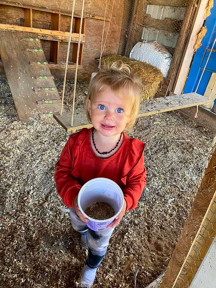 Laikyn is registered to the contest to win money with this photo: child, cup, drink, flooring, fun, grass, hand, happy, landscape, leisure, people, people_in_nature, person, play, reading, sitting, soil, t_shirt, toddler, water