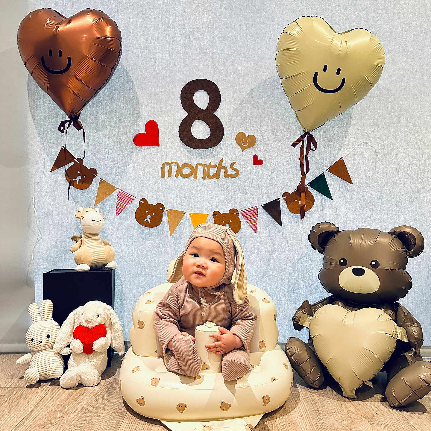 Desmond joined the competition — help win amazing prizes! baby, balloons, banner, bear_balloon, bunny_outfit, celebration, child, cute, decorations, happy, heart_balloon, indoor, infant, inflatable_chair, milestone, person, plush_toys, smile, toy, wooden_floor