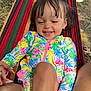 baby, casual, child, colorful_clothing, earring, ground, hammock, hand_holding, happy, legs, nature, outdoor, person, portrait, shorts, sitting, smiling, sunlight, toddler, tree