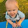 baby, blue_eyes, skateboard, grass, sunlight, shadow, outdoor, child, happy, smiling, short_hair, hands, shirt, playing, daylight, cute, person, closeup, weekdays, time