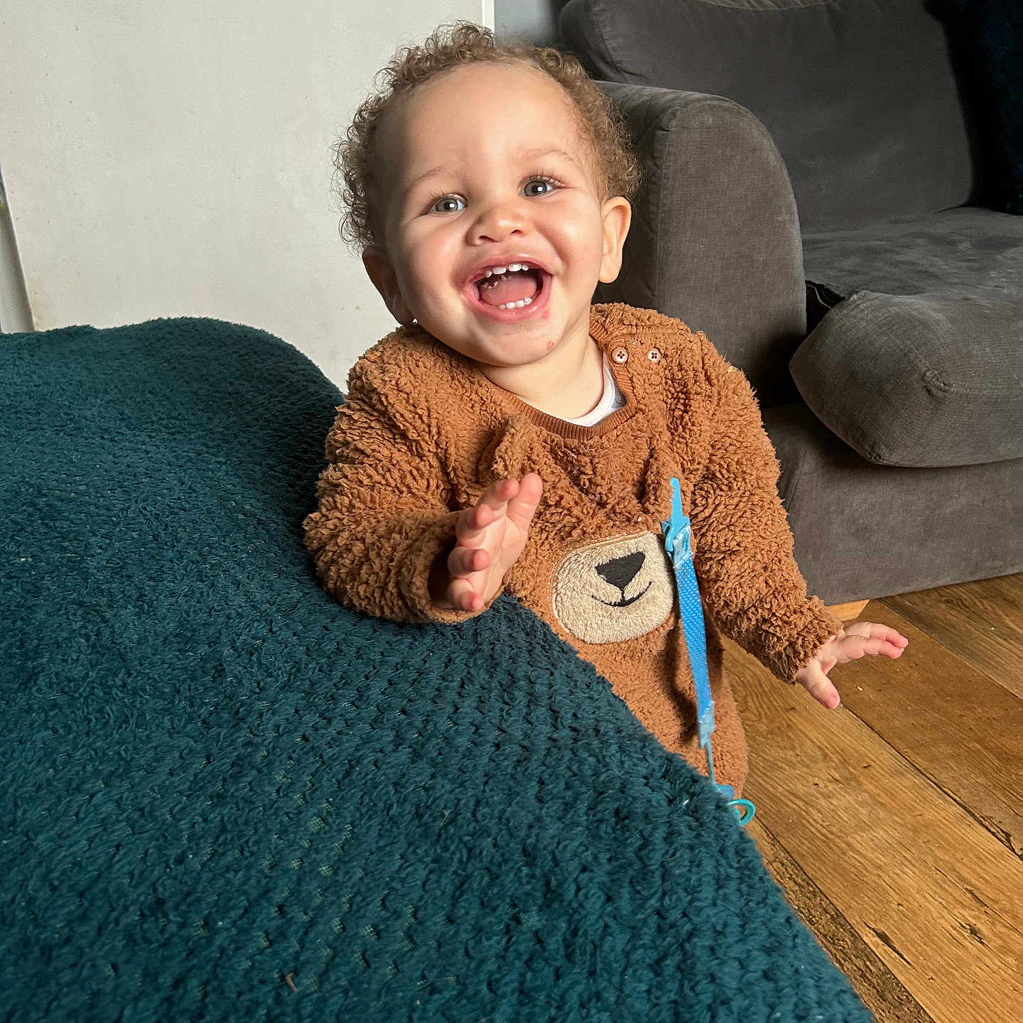 Micaiah is registered to the contest to win money with this photo: architecture, baby, babylaughing, building, clothing, couch, cushion, face, furniture, happy, head, indoors, knitwear, laughing, livingroom, person, photography, portrait, room, sweater