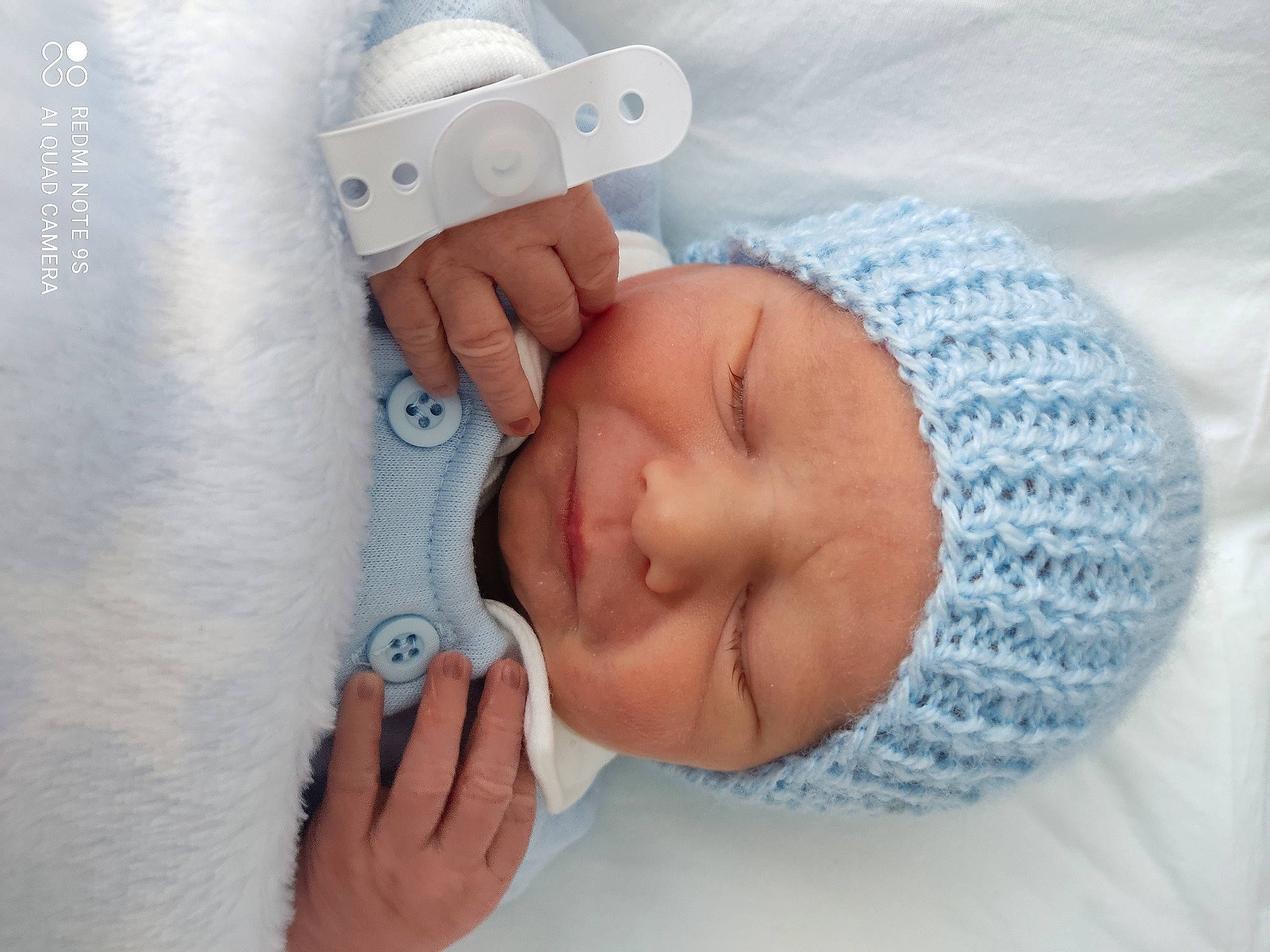 Ryder is registered to the contest to win money with this photo: baby, baby_products, baby_sleeping, baby_toddler_clothing, bedtime, cap, child, comfort, eyelash, fashion_accessory, finger, gesture, hand, headgear, headwear, linens, nail, person, skin, textile
