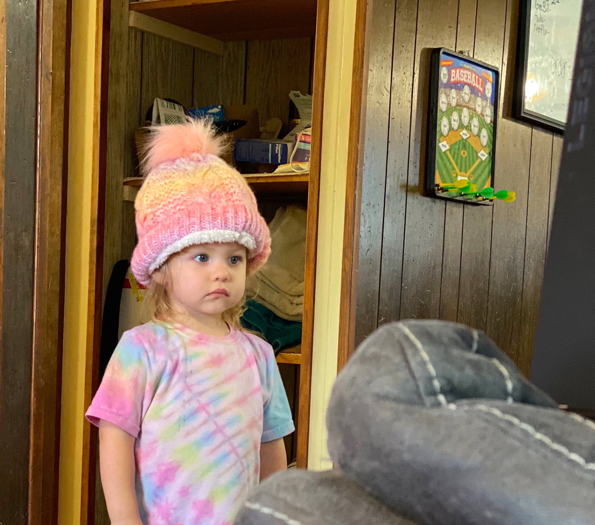 Sawyer is registered to the contest to win money with this photo: baby_toddler_clothing, cap, child, fun, happy, hat, headgear, headwear, helmet, house, leisure, magenta, people, person, recreation, room, standing, sun_hat, toddler, vacation