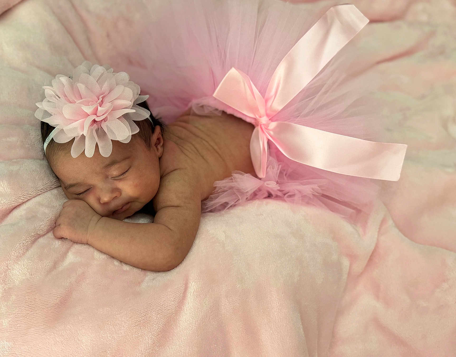Amyra is registered to the contest to win money with this photo: baby, sleeping, pink_tutu, headband, flower, blanket, soft_texture, infant, peaceful, cute, newborn, resting, delicate, fabric, tulle, bow, skin, closeup, portrait, child