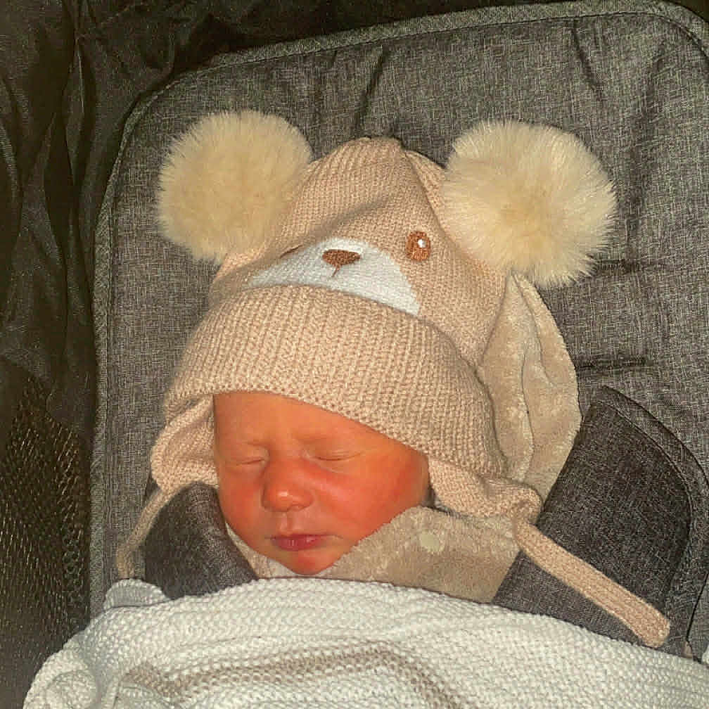 Cara is registered to the contest to win money with this photo: baby, bear_ears, blanket, child, closed_eyes, cozy, cushion, cute, face, hat, infant, knit_hat, newborn, pom_poms, sleeping, soft_texture, striped_blanket, stroller, warm, winter_clothing