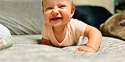 Merrin is registered to the contest to win money with this photo: baby, child, crawling, smiling, toothy_grin, hair_tufts, bed, blanket, indoor, soft_lighting, cute, infant, happy, person, portrait, toddler, clothing, skin, closeup, expression