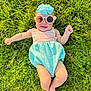 Merrin is registered to the contest to win money with this photo: baby, grass, sunglasses, bow, smile, sunshine, outdoor, child, cute, playful, fashion, headwear, summer, greenery, infant, happy, lying_down, legs, arms, nature