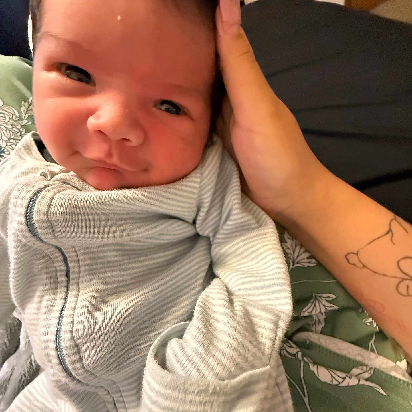 Benito joined the competition — help win amazing prizes! baby, infant, onesie, hand, tattoo, face, expression, close_up, portrait, sleepwear, skin, person, cute, cozy, resting, bed, blanket, indoor, comfort, newborn