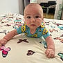 baby, bed, bedspread, blue_clothing, butterfly_pattern, child, crawling, curious, expression, eyes, face, floor, furniture, hands, indoor, infant, person, portrait, skin, spongebob