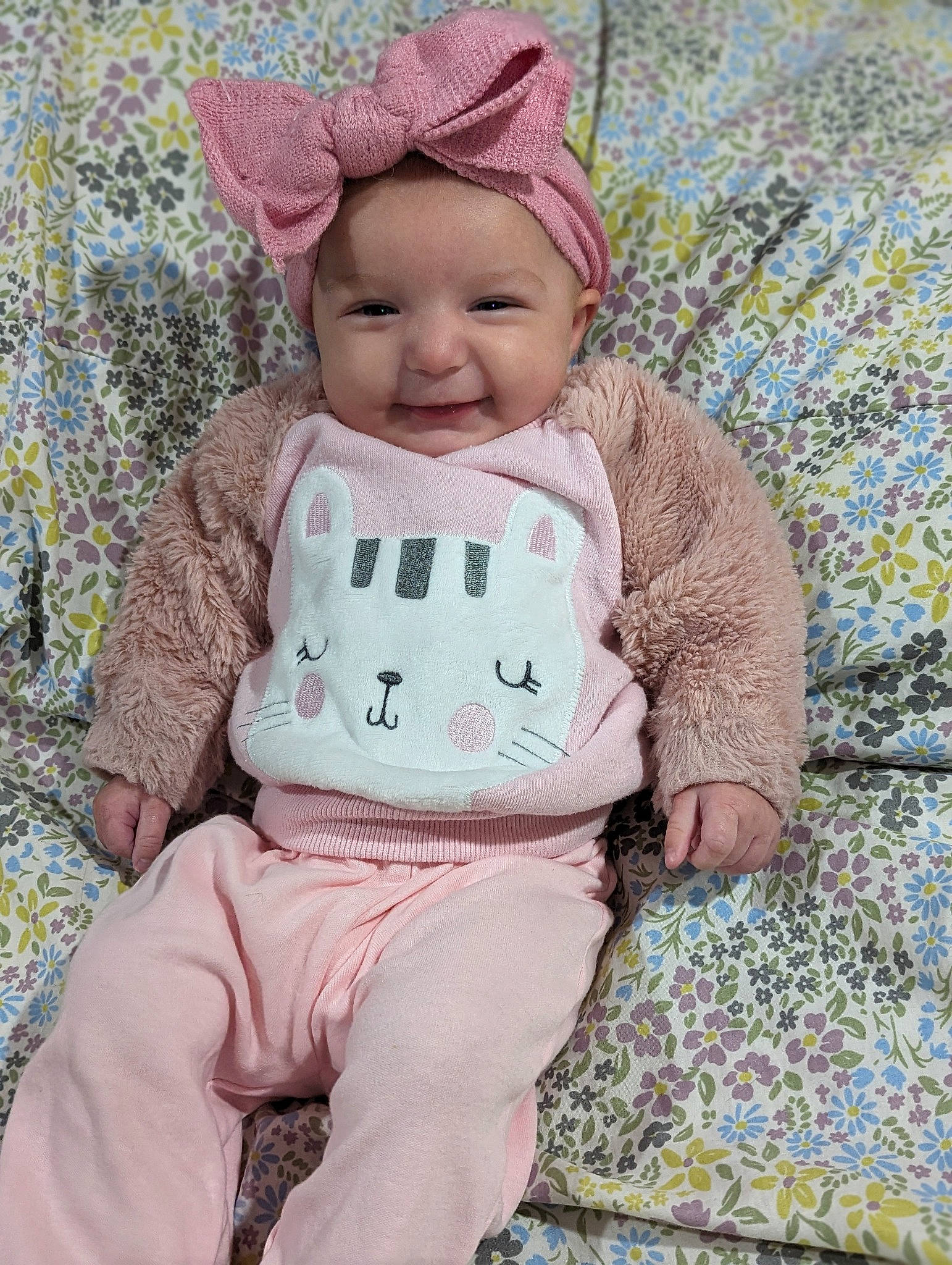 Payton is registered to the contest to win money with this photo: baby, baby_toddler_clothing, cap, cheek, child, face, fashion_accessory, happy, headwear, joy, knit_cap, linens, magenta, outerwear, pattern, person, pink, skin, sleeve, smile