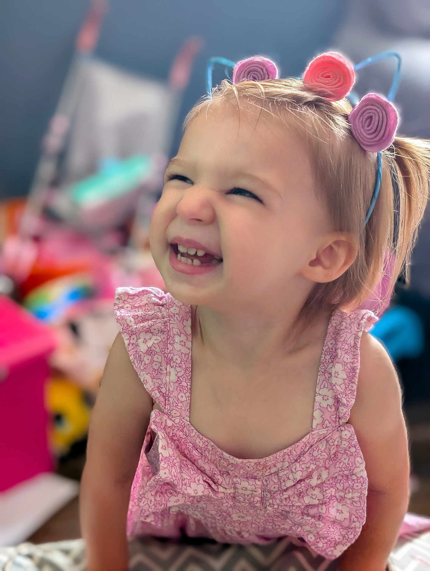 Payton joined the competition — help win amazing prizes! toddler, child, smiling, happy, pink_dress, headband, indoor, portrait, cute, playful, face, young_child, blonde_hair, expression, toy, colorful_background, cheerful, person, closeup, baby
