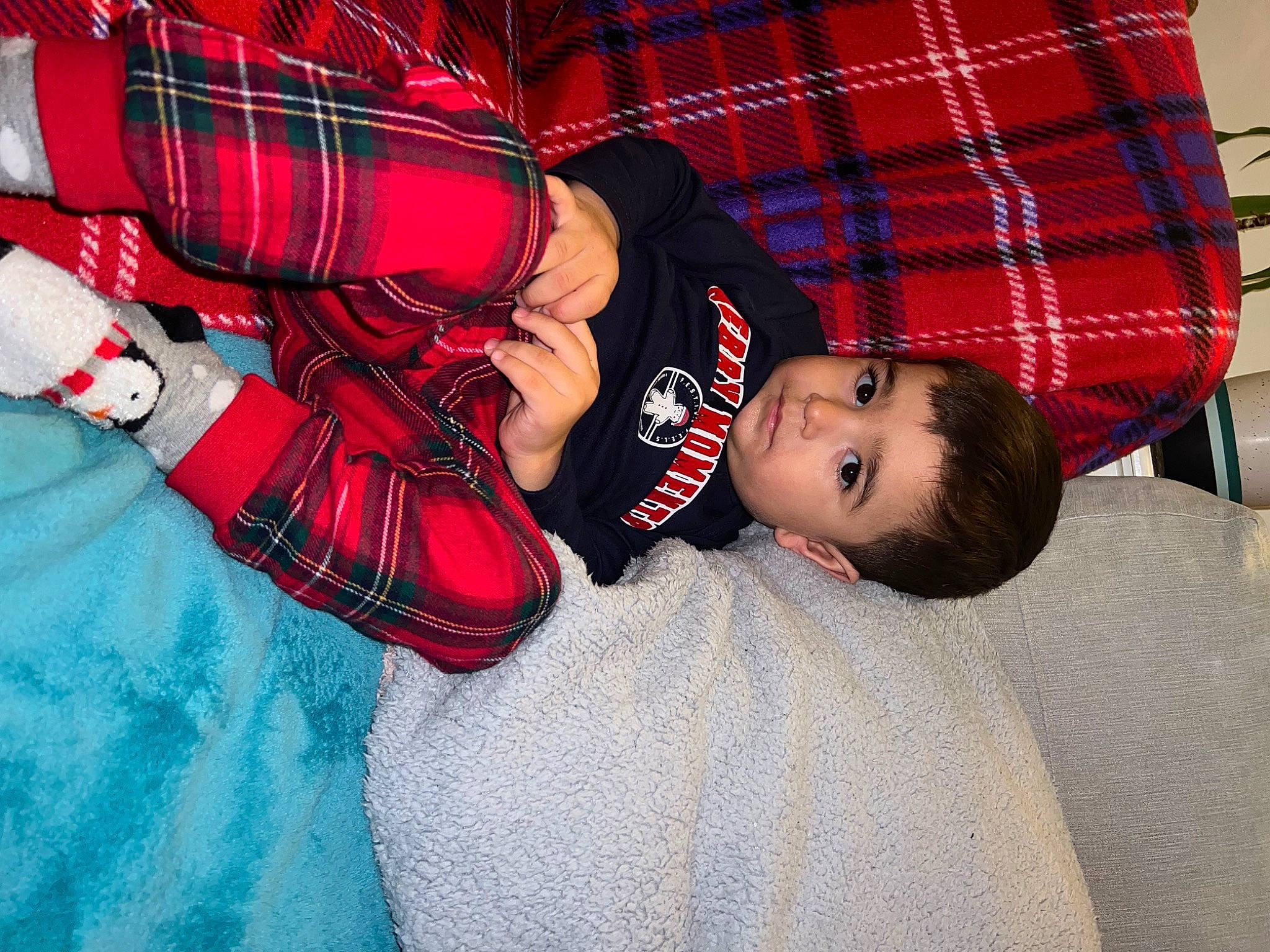 Steven is registered to the contest to win money with this photo: baby, baby_toddler_clothing, carmine, child, comfort, elbow, electric_blue, flooring, fun, happy, pattern, person, plaid, red, sitting, sleeve, tartan, textile, thigh, toddler