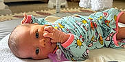 Madison is registered to the contest to win money with this photo: baby, blanket, carpet, child, colorful_clothing, couch, cute, face, hand, indoors, infant, lying_down, newborn, pacifier, pajamas, peaceful, play_mat, plush_toys, room, soft_toys