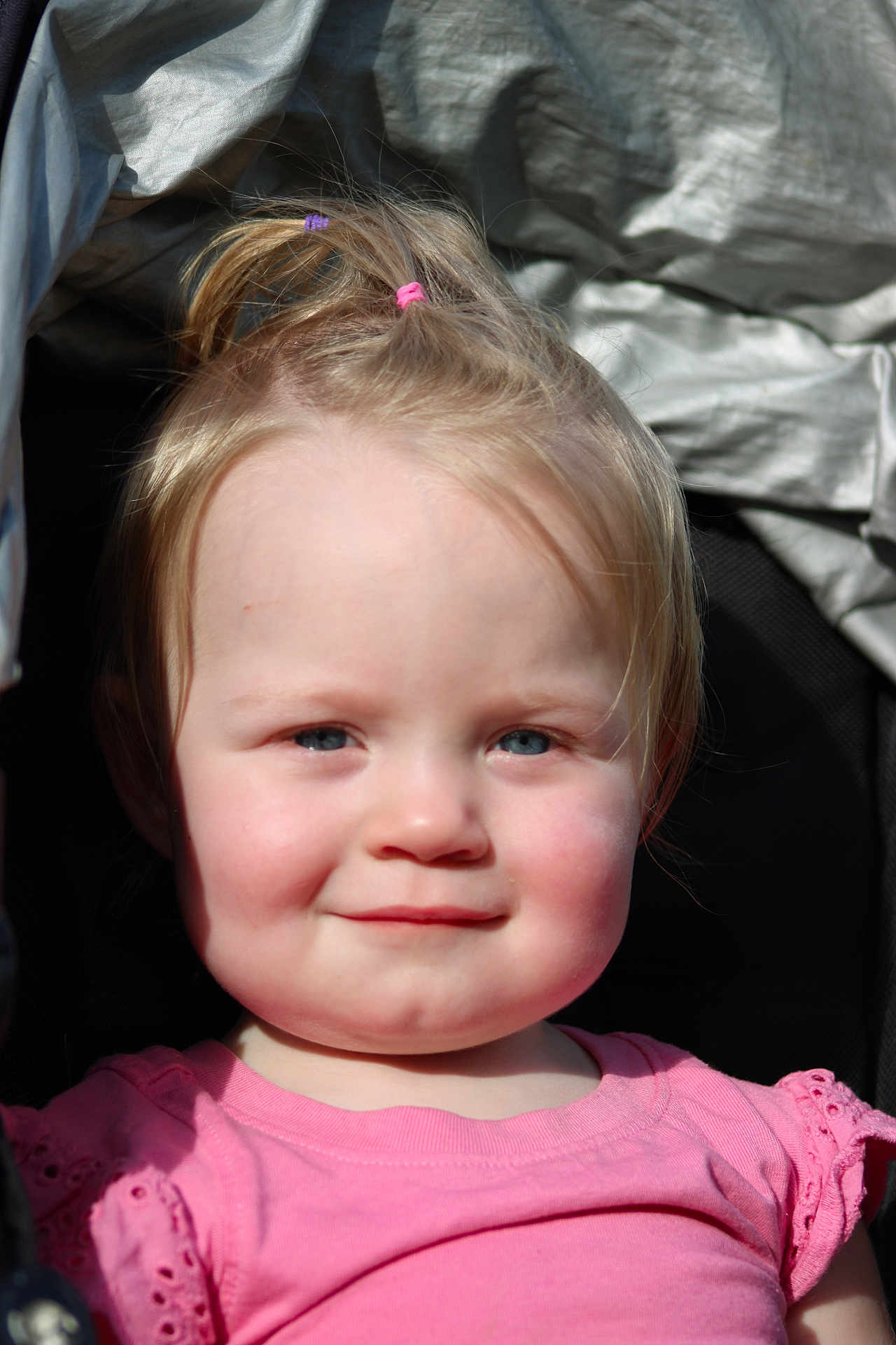 Athena is registered to the contest to win money with this photo: toddler, child, girl, blonde_hair, pink_shirt, smile, portrait, face, rosy_cheeks, sunlight, outdoor, cute, happy, baby, young_child, person, closeup, headshot, casual_clothing, natural_light
