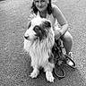 animal, black_and_white, casual, crouching, daylight, dog, friendship, fur, grass, happy, leash, leisure, nature, outdoor, pet, portrait, road, smile, walking, woman