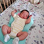 baby, sleeping, crib, cushion, butterfly_pattern, soft_toys, onesie, white_socks, nursery, bed, blanket, peaceful, infant, child, indoor, resting, cute, comfortable, pillow, sleep