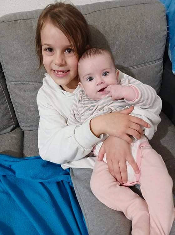 Yasmine participe au concours pour gagner de l'argent avec cette photo : arm, baby, baby_toddler_clothing, blue, cheek, comfort, couch, dress, face, fun, gesture, hair, happy, head, iris, joy, leg, person, skin, sleeve