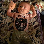 Josie joined the competition — help win amazing prizes! baby, infant, onesie, mittens, blanket, floral_pattern, pants, heart_pattern, lying_down, curious_expression, face, person, toddler, clothing, fabric, wipes, packaging, indoor, soft_lighting, cute