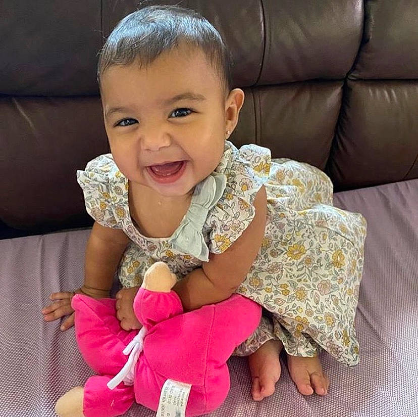 Julianna joined the competition — help win amazing prizes! arm, baby, beauty, cheek, child, cool, face, facial_expression, finger, hand, happy, head, human, joy, outerwear, people, person, pink, sitting, skin