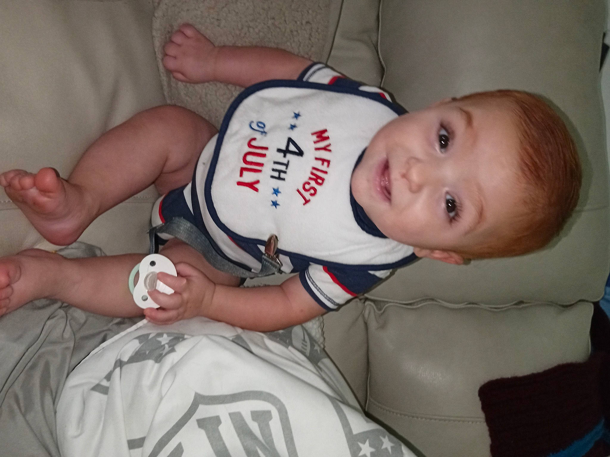 Caeden is registered to the contest to win money with this photo: arm, baby, baby_toddler_clothing, cheek, chest, child, comfort, elbow, finger, hand, head, joint, knee, mammal, muscle, person, sleeve, sports_uniform, thigh, toddler