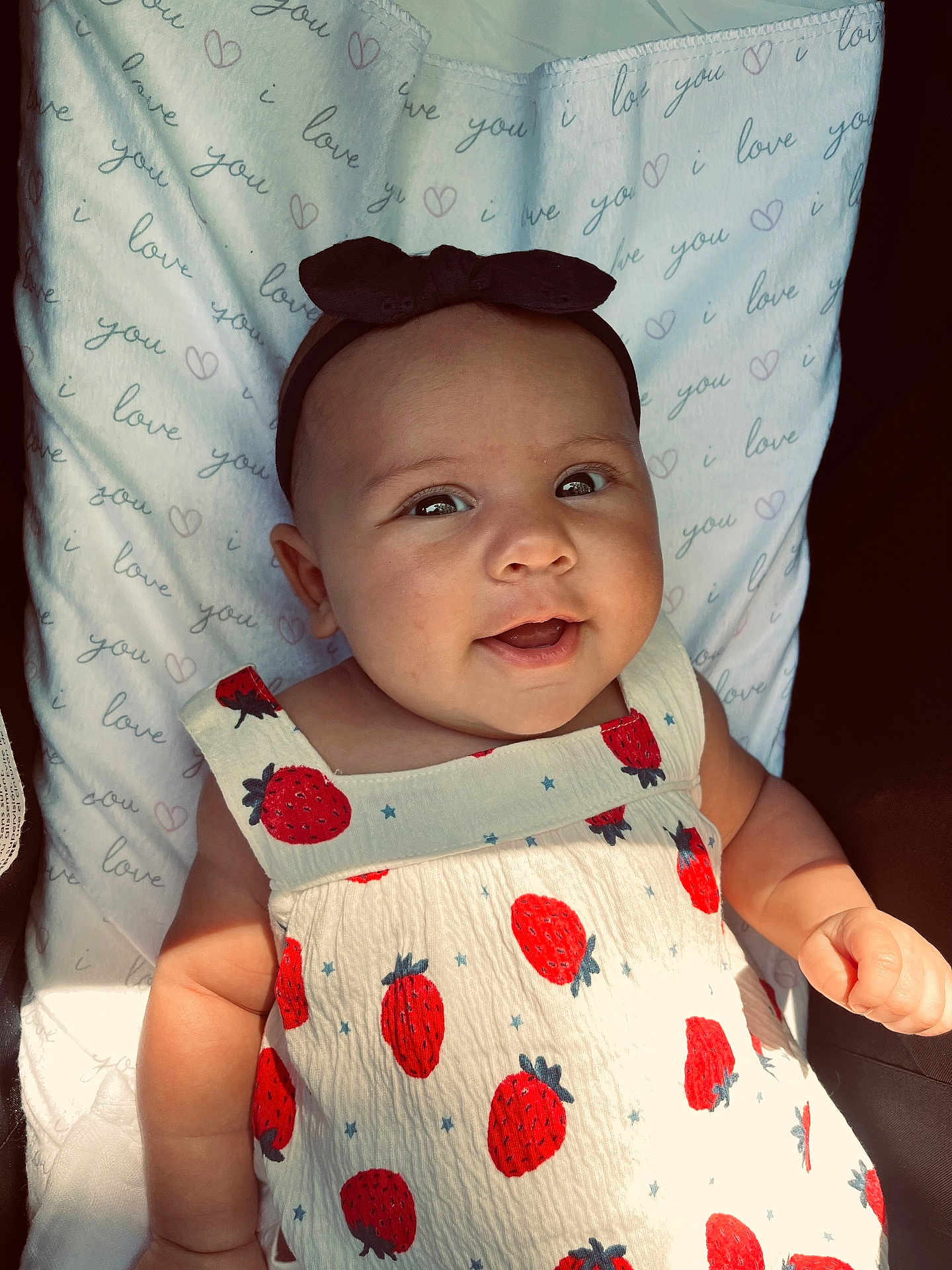 Edith joined the competition — help win amazing prizes! baby, infant, child, smiling, headband, dress, strawberry_pattern, blanket, text, love, cute, happy, chubby_cheeks, portrait, closeup, sunlight, indoors, person, young, clothing