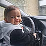 Shaïna a rejoint le concours — aidez-le/la à gagner de superbes lots ! toddler, child, car, steering_wheel, panda_hoodie, smile, face, hand, window, dashboard, keys, seat, clothing, indoors, cute, young, portrait, vehicle_interior, black_and_white, happy