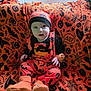 baby, child, halloween, costume, orange, black, blanket, pumpkin, bat, spiderweb, spider, hat, booties, indoors, window, curtain, face, sitting, cute, festive