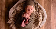 Bakari joined the competition — help win amazing prizes! baby, basket, blanket, cozy, cute, hands_together, hat, indoors, infant, knit, newborn, peaceful, portrait, resting, sleeping, soft_texture, tiny_feet, warm, wooden_floor, wrapped