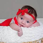 Elaina is registered to the contest to win money with this photo: baby, infant, red_bow, headband, blue_eyes, blanket, basket, cute, portrait, child, soft_texture, lying_down, white_blanket, pink_trim, indoors, closeup, adorable, small_hands, curious_expression, soft_lighting