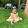 toddler, child, grass, yellow_dress, white_bow, outdoor, trees, truck, greenery, barefoot, cute, portrait, sitting, nature, daylight, lace, expression, young_child, park, sunlight