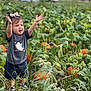 Emma joined the competition — help win amazing prizes! toddler, child, pumpkin_patch, plants, greenery, orange_pumpkins, grass, shorts, shirt, bow, shoes, outdoor, nature, daylight, field, expression, arms_raised, cute, happy, young_child