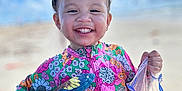 Emma joined the competition — help win amazing prizes! child, toddler, smiling, outdoor, sunny, blue_sky, clouds, floral_swimsuit, colorful_clothing, plastic_bag, red_slushy, happy, portrait, summer, vacation, cute, standing, sunshine, playful, young_child