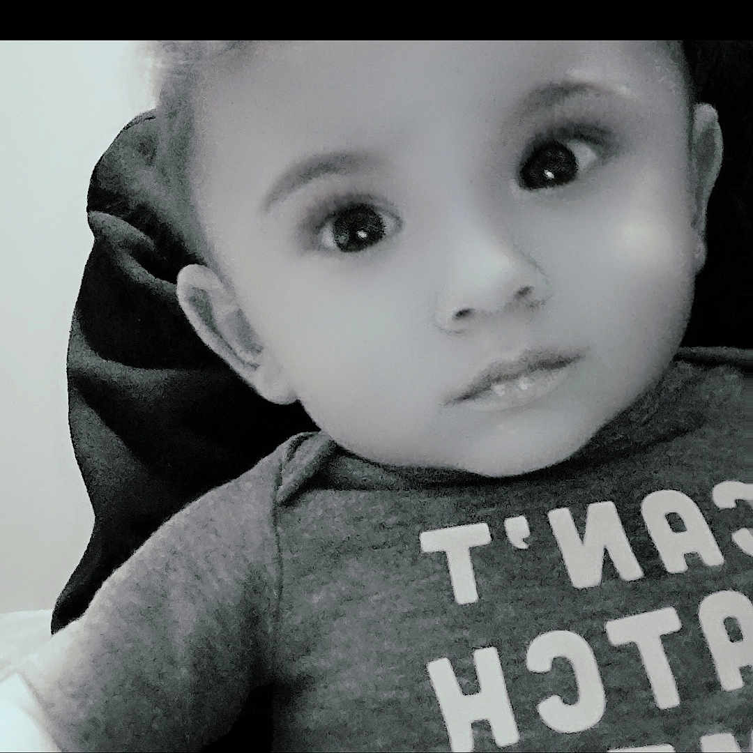 Johnathan is registered to the contest to win money with this photo: advertisement, baby, bonnet, cap, clothing, face, frown, hat, head, hood, hoodie, knitwear, newborn, person, photography, portrait, poster, sweater, sweatshirt, t_shirt