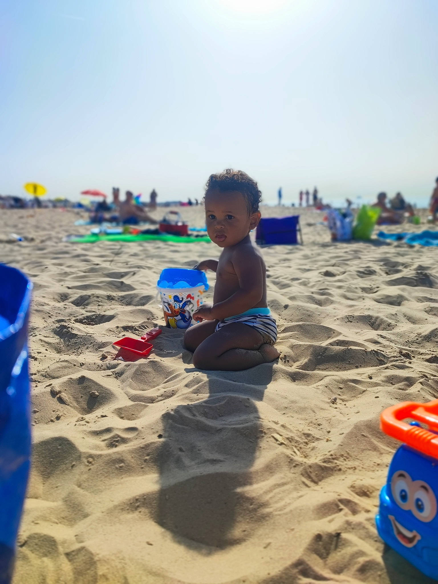 Aaron participe au concours pour gagner de l'argent avec cette photo : beach, blue, child, fun, hat, horizon, landscape, leisure, natural_environment, nature, people_in_nature, people_on_beach, person, play, recreation, shore, shorts, sky, sun_tanning, toddler